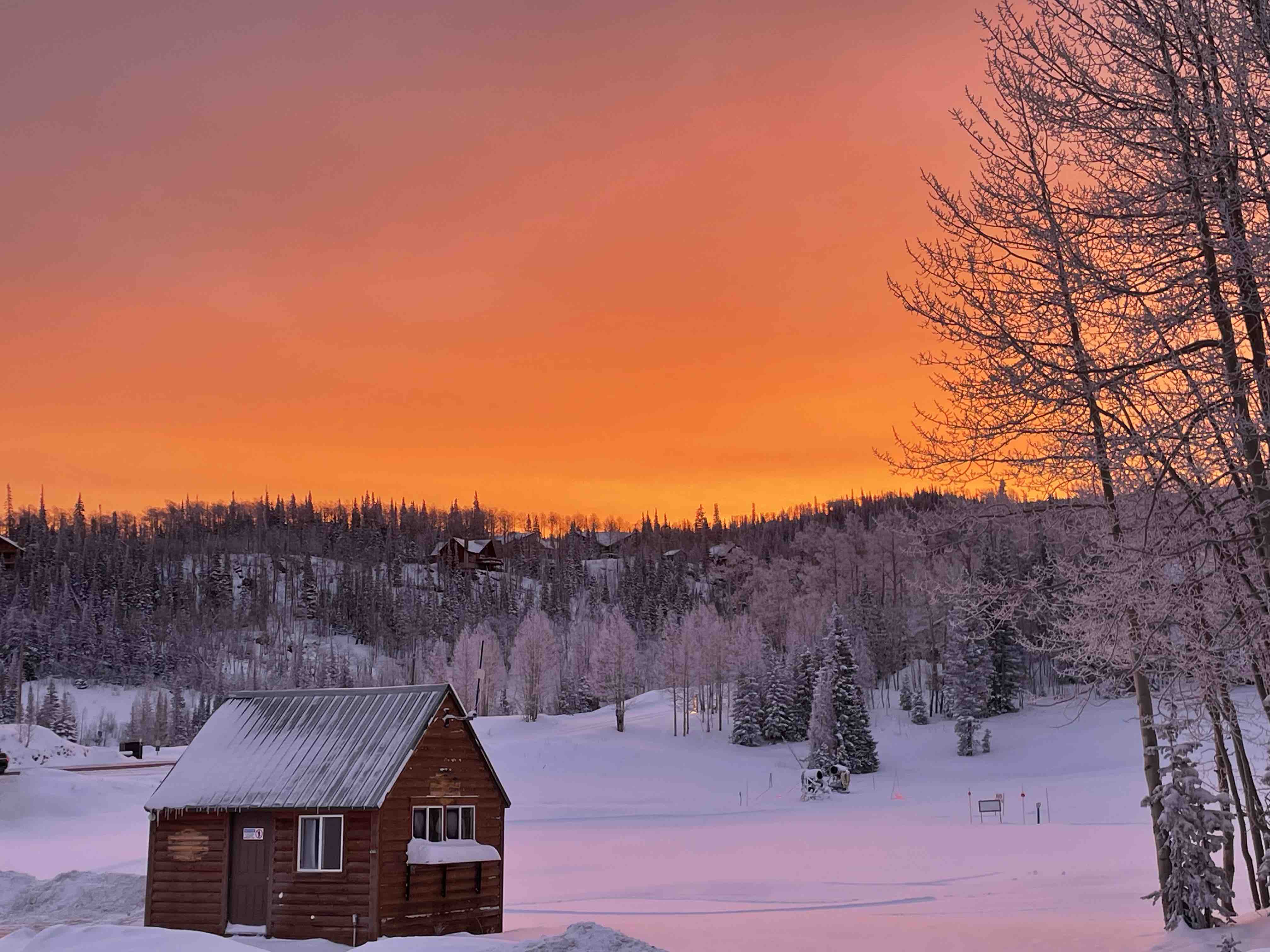 Small cottage at sunset in the snow